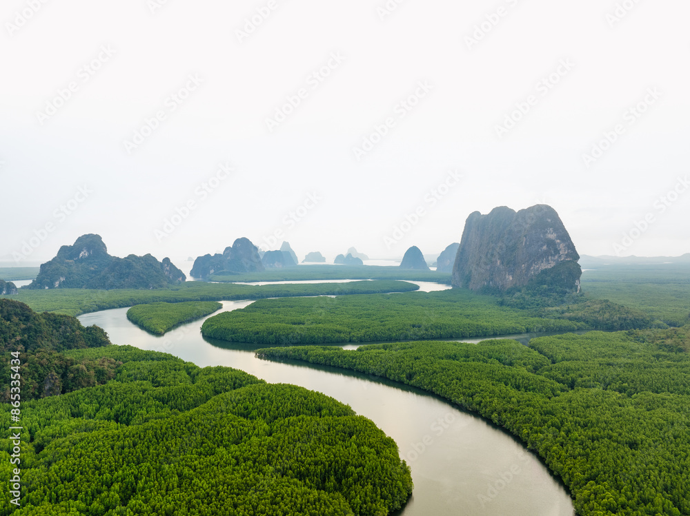 View from above, aerial shot, stunning view of Ao Phang Nga (Phang Nga Bay) National Park featuring a multitude of limestone formations rising from the sea. Thailand.