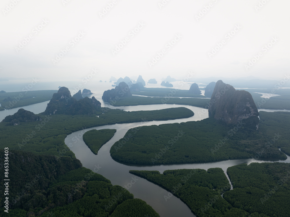 View from above, aerial shot, stunning view of Ao Phang Nga (Phang Nga Bay) National Park featuring a multitude of limestone formations rising from the sea. Thailand.
