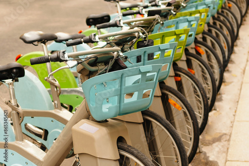 City bike sharing station filled with colorful bicycles, providing convenient urban transport options.
