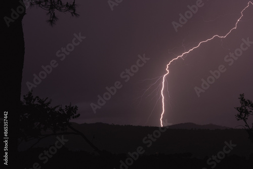 Obraz na płótnie Stunning view of a lightning hit the ground during a thunderstorm in Italy. w salonie