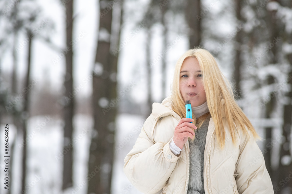 Portrait of a young beautiful blonde girl outdoors in winter in cloudy weather. Portrait of a young beautiful blonde girl outdoors in winter in cloudy weather.