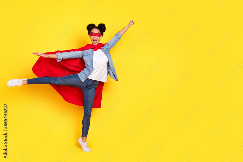 Full body portrait of nice young girl empty space ad superhero costume isolated on yellow color background Full body portrait of nice young girl empty space ad superhero costume isolated on yellow color background