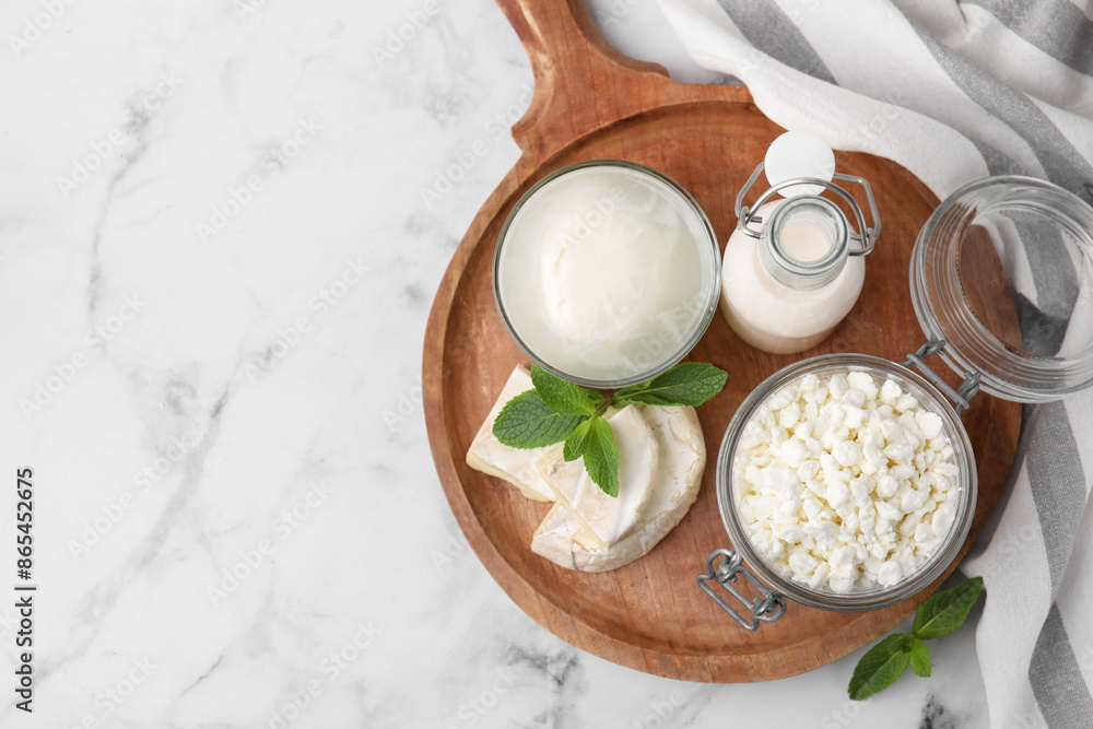 Different dairy products and mint on white marble table, top view. Space for text Different dairy products and mint on white marble table, top view. Space for text