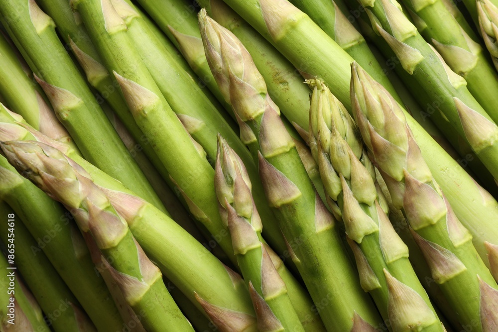 Fresh green asparagus stems as background, top view Fresh green asparagus stems as background, top view