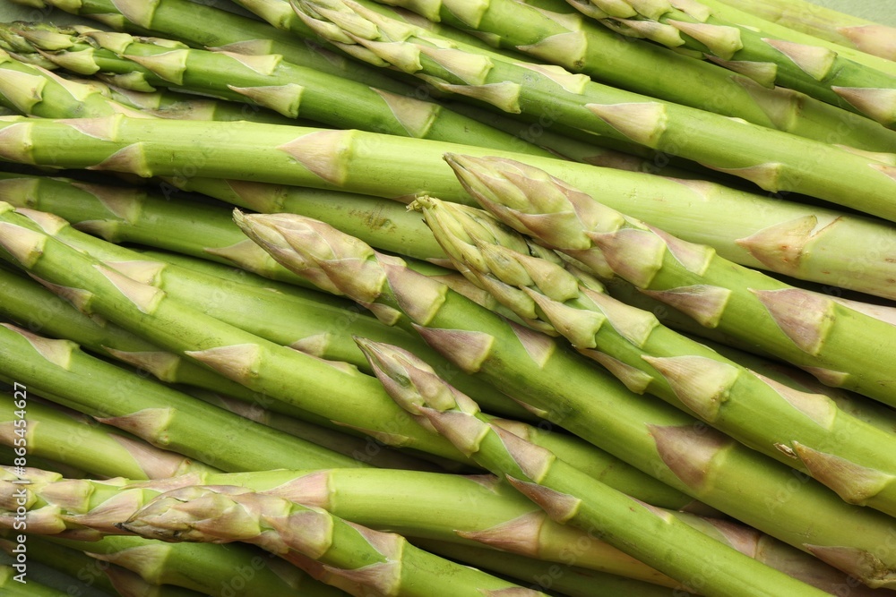 Fresh green asparagus stems as background, top view Fresh green asparagus stems as background, top view