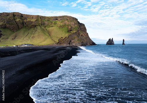 Fototapeta Naklejka Na Ścianę i Meble -  Aerial view of Reynisfjara black sand beach and sea stacks in Iceland.