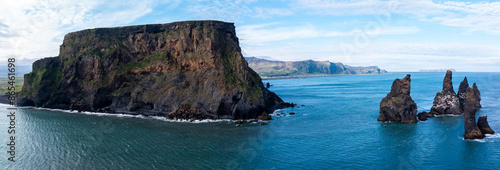 Aerial view of the cliffs and sea stacks at Reynisfjara black sand beach, Iceland. photo