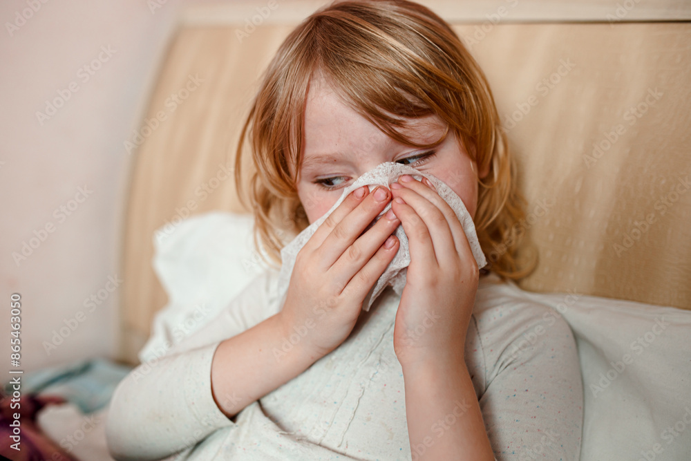 Young Girl Blowing Her Nose While Lying In Bed Young Girl Blowing Her Nose While Lying In Bed