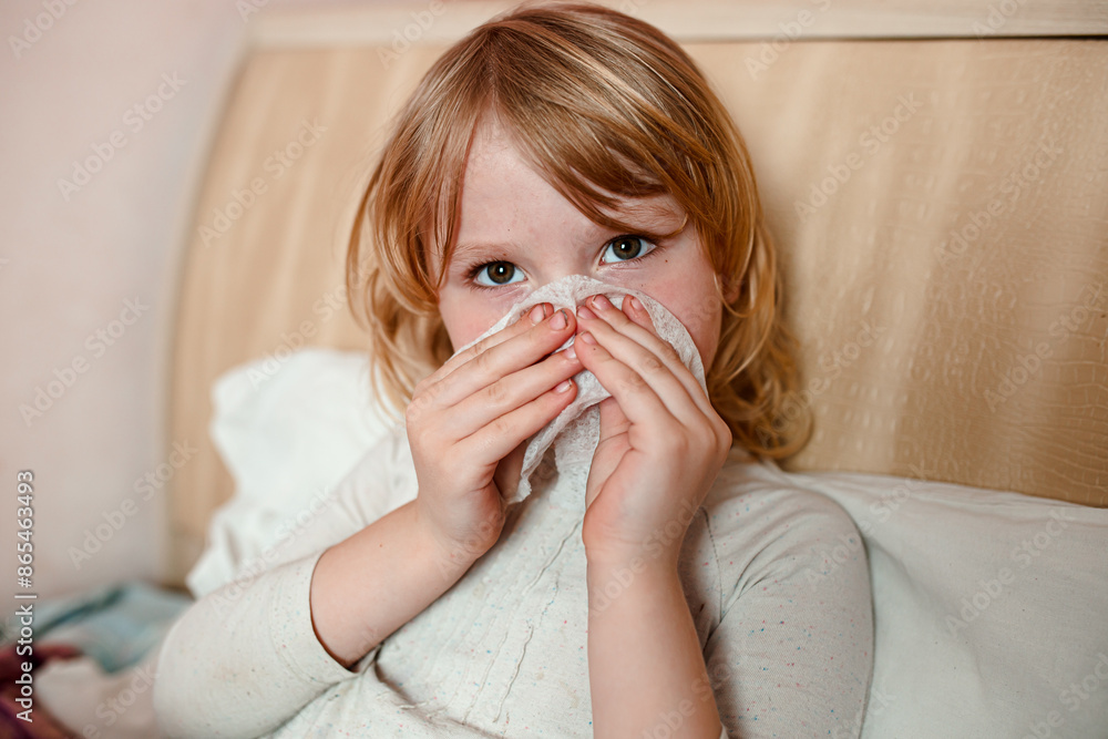 Young Girl Blowing Her Nose While Sitting In Bed Young Girl Blowing Her Nose While Sitting In Bed