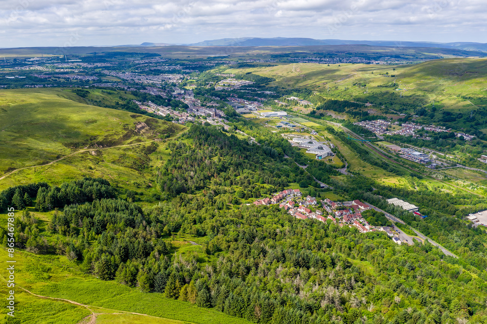 Green hills, trees and a small town in a deep valley Green hills, trees and a small town in a deep valley