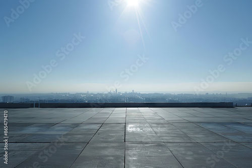 a view of a city from a rooftop with a sun shining on it © Kitta