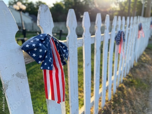 American flag on white picket fence photo