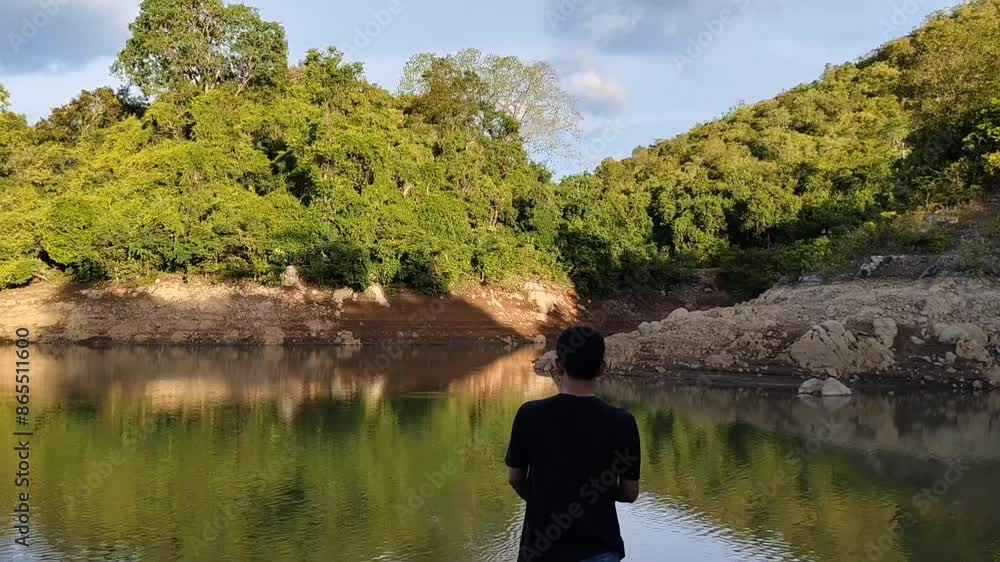 a man was throwing his fishing bait into the water a man was throwing his fishing bait into the water