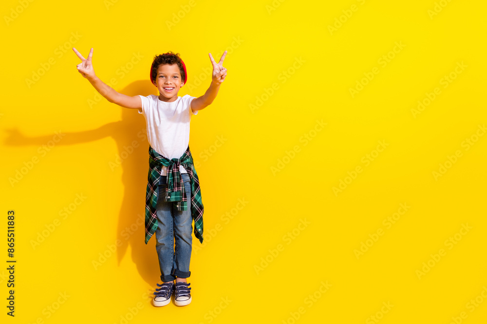 Full body photo of cute little boy show v-sign dressed stylish white clothes isolated on yellow color background Full body photo of cute little boy show v-sign dressed stylish white clothes isolated on yellow color background