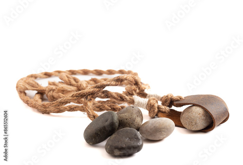 Antique Sling Shot and Stones on a White Background from the Story of David and Goliath in the Bible