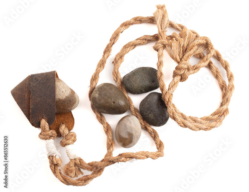 Canvas Print Antique Sling Shot and Stones on a White Background from the Story of David and