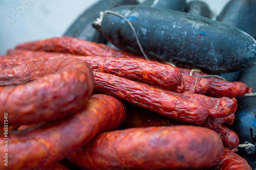 Quadro su tela portuguese traditional sausages, chorizo, sausage and black pudding, The image shows red chorizo and dark blood sausages on a metal plate,  ready for grilling