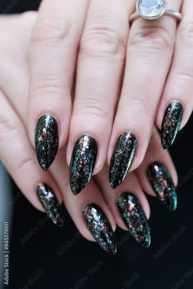 Female hands with long nails and black and red nail polish Female hands with long nails and black and red nail polish