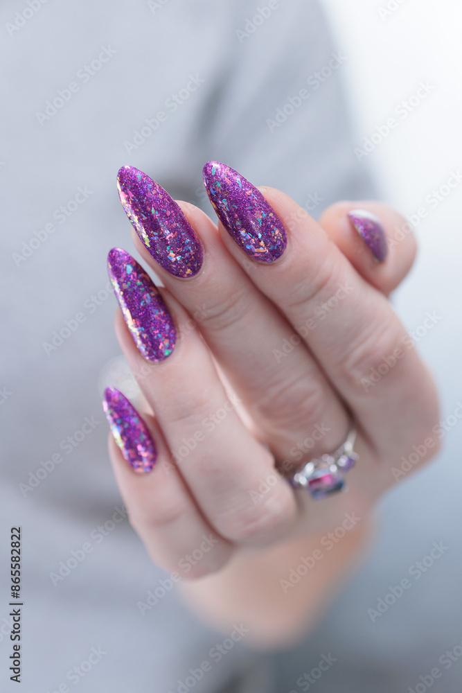 Female hand with long nails and purple plum manicure Female hand with long nails and purple plum manicure