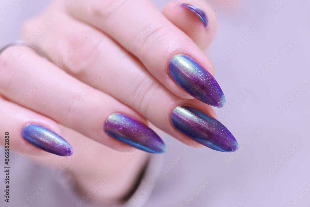 beautiful female hand with long nails, purple and blue manicure beautiful female hand with long nails, purple and blue manicure