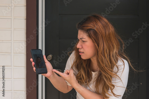 A woman in her 30s confronts her husband at the door, discovering another woman's social media and chats on his. Point of view of partner.