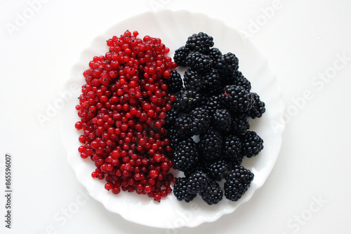 red currants and blackberries on a plate