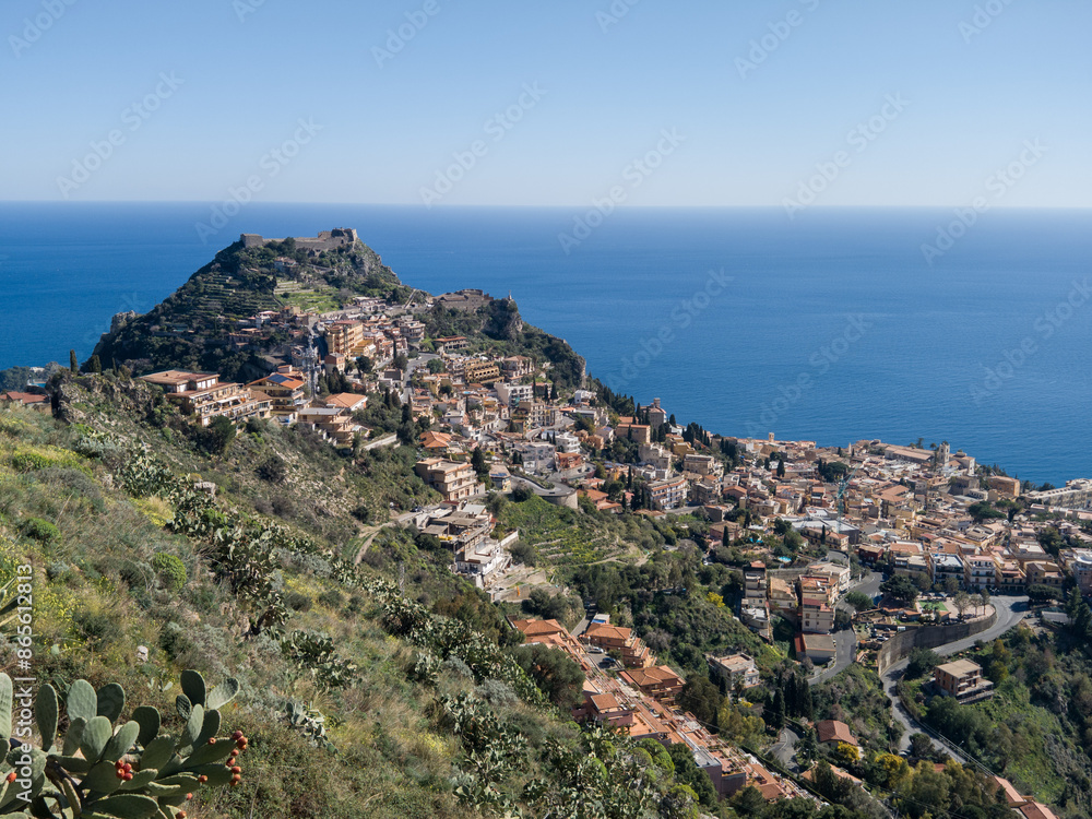 Chiesa di San Biagio of Castelmola with panoramic view on coastline of Ionian Mediterranean sea near Taormina, Sicily, Italy, Europe, EU. A field of cactus around the church at sunset golden hour time Chiesa di San Biagio of Castelmola with panoramic view on coastline of Ionian Mediterranean sea near Taormina, Sicily, Italy, Europe, EU. A field of cactus around the church at sunset golden hour time