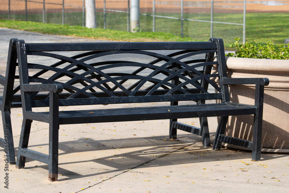 black wrought iron bench in park black wrought iron bench in park