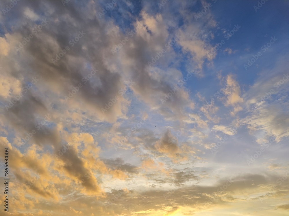Obraz premium blue bright and orange yellow dramatic sunset sky in countryside texture background.