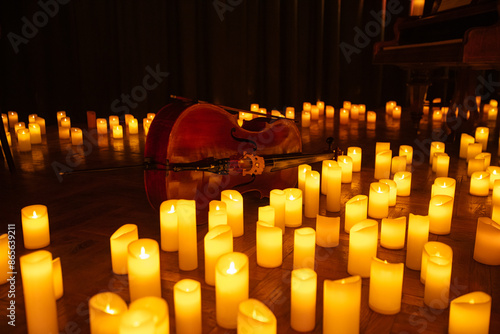 closeup of violin with lots of candles photo