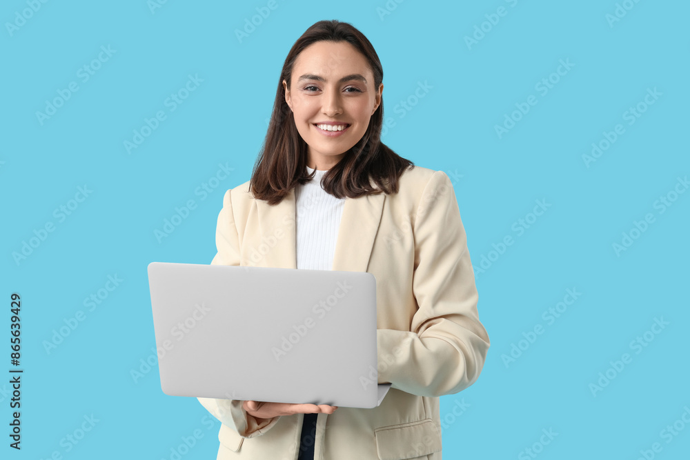 Young businesswoman with laptop on blue background Young businesswoman with laptop on blue background