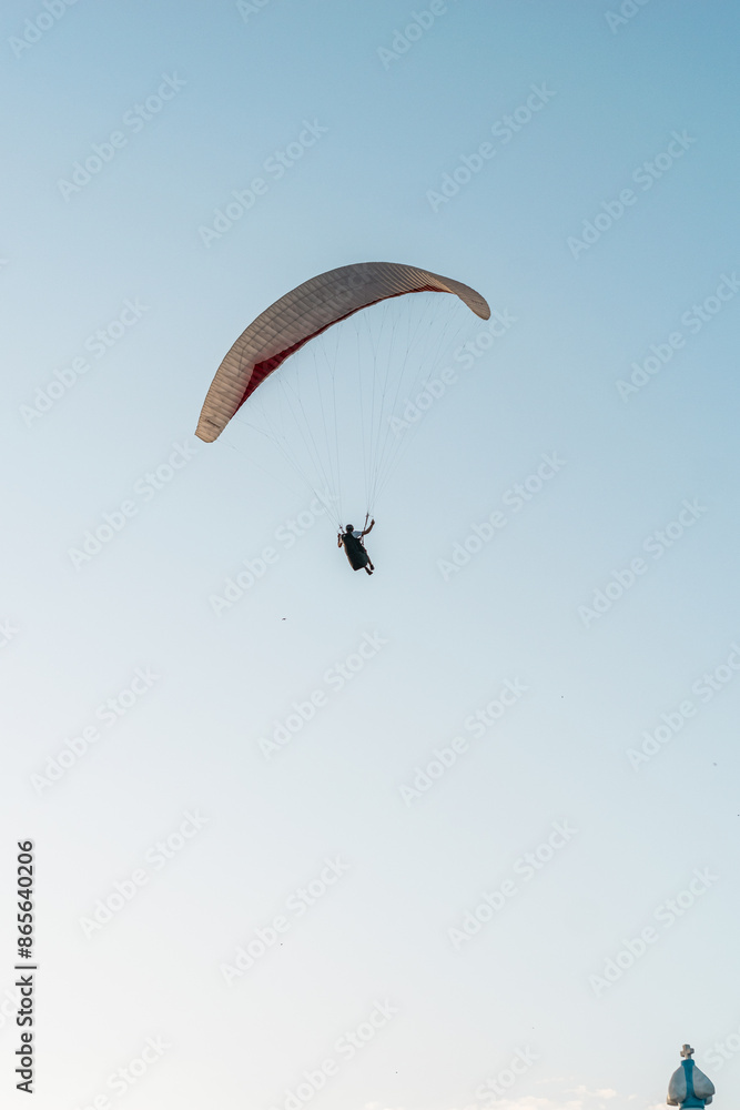 Paragliders in the sky. Man paragliding in a blue sky, on Cerro el Morro from Lechería, Venezuela Paragliders in the sky. Man paragliding in a blue sky, on Cerro el Morro from Lechería, Venezuela