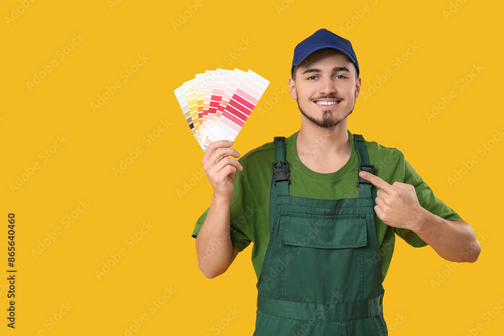 Young painter with color palettes on yellow background Young painter with color palettes on yellow background