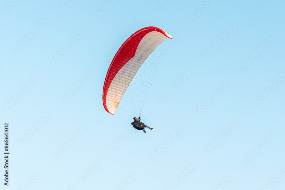 Paragliders in the sky. Man paragliding in a blue sky, on Cerro el Morro from Lechería, Venezuela Paragliders in the sky. Man paragliding in a blue sky, on Cerro el Morro from Lechería, Venezuela