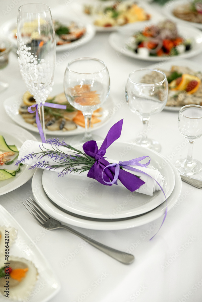 Empty glasses and dishes on a wedding table with flowers Empty glasses and dishes on a wedding table with flowers
