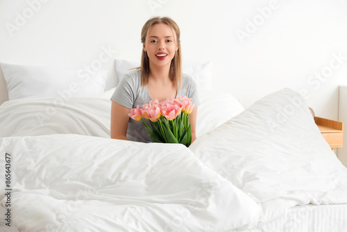 Happy young woman sitting o...