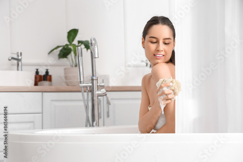 Young woman with loofah beh...