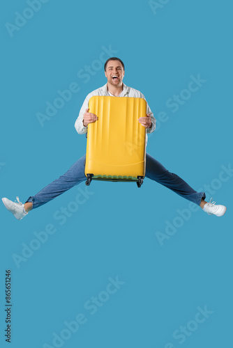 Young happy man jumping wit...