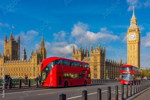 Houses of Parliament with Big Ben and double-decker buses on Westminster bridge, London, UK photo