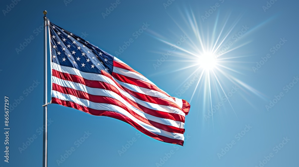 Naklejka premium The United States flag flowing majestically in the wind, each detail of the stars and stripes clear, against a bright and sunny sky, representing unity and liberty