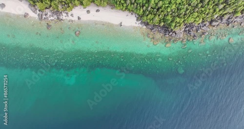 rocky coastline with clear blue water  from above 