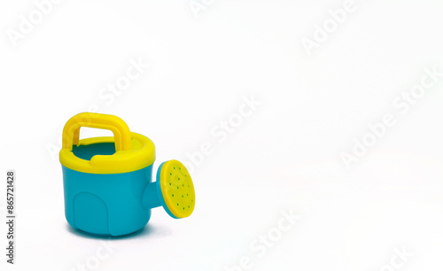 Children's toys for playing in the sand. Two watering cans for sandpit on white background. For text