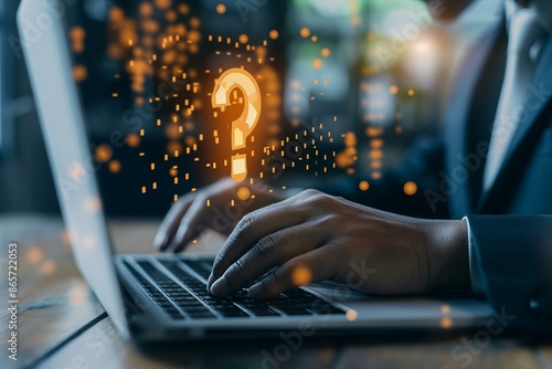 A business professional typing on a laptop with a floating exclamation mark hologram symbolizing important or urgent information.