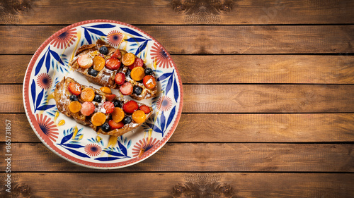 French toast with chopped fruit, strawberries, blueberries and cape gooseberry