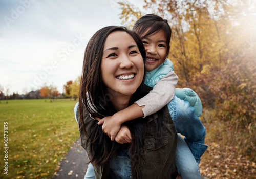 Portrait, asian family and piggy back for walk, bonding together and countryside for holiday. Face, parent and girl with smile, outdoor and mother carrying kid, nature and energy with game or playing