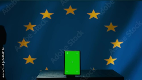 European Union counterintelligence division uses green screen tablet to protect against propaganda affecting elections. EU security service safeguarding democracy online using mockup device, camera B photo