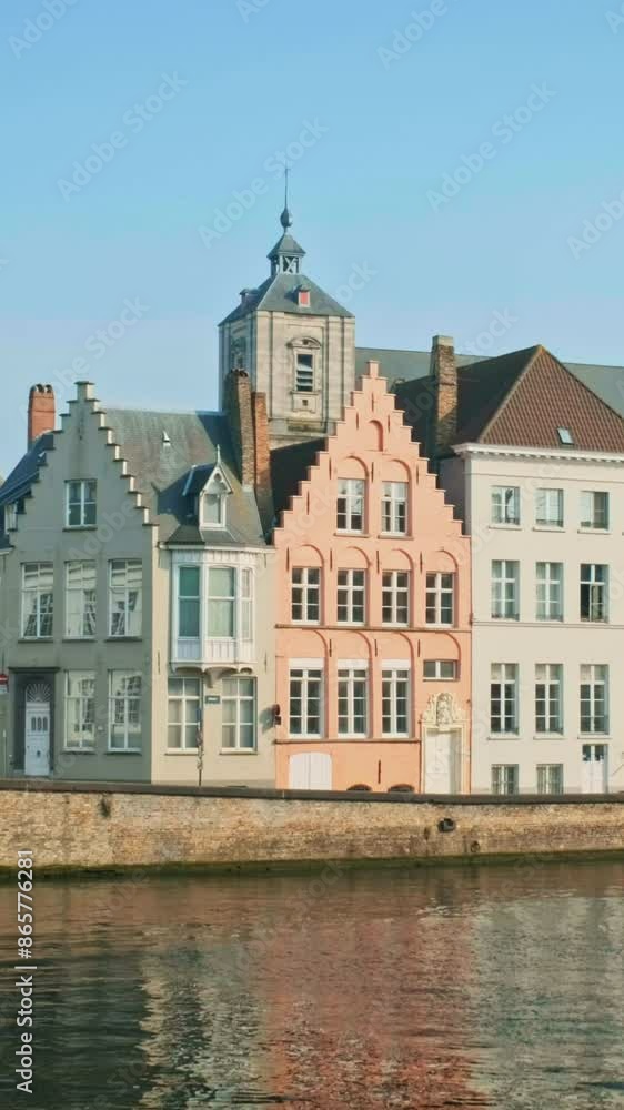 Old houses and canal in famous tourist town of Bruges (Brugge) on sunset, Belgium. Car passing by in the street. Horizontal camera pan Old houses and canal in famous tourist town of Bruges (Brugge) on sunset, Belgium. Car passing by in the street. Horizontal camera pan