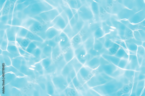 Blue water with ripples on the surface. Defocus blurred transparent blue colored clear calm water surface texture with splashes and bubbles. Water waves with shining pattern texture background.