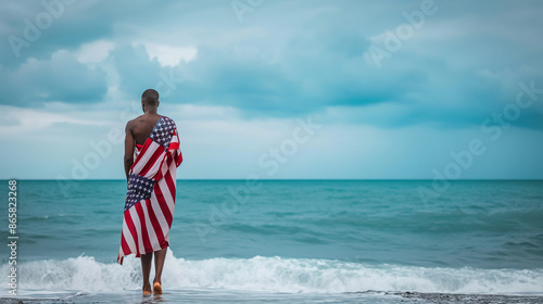 patriot on the beach with the american flag independence day