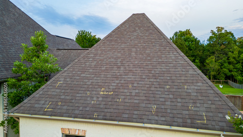 Roof with hail damage and marking from hail insurance inspection